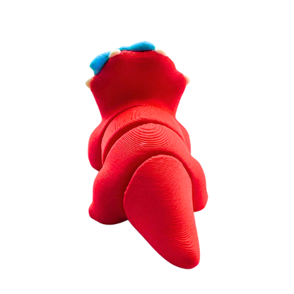 Red triceratops toy with large blue bow on frill, Fancy Edition collectible figure