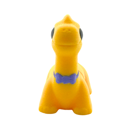 Monty the Brachiosaurus Flexling toy in yellow with purple fancy bow tie, limited edition collectible dinosaur figure