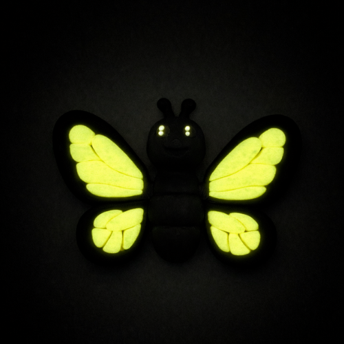 Aurora the Butterfly Flexling with black body and iridescent blue-green wings, poseable collectible toy from Original Crew