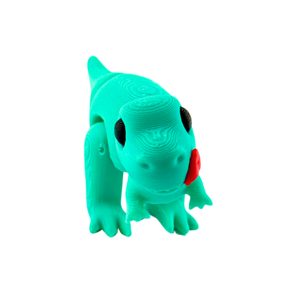 Roary the T-Rex Nom Nom Edition collectible toy in shimmery turquoise finish with tongue out in playful hungry pose