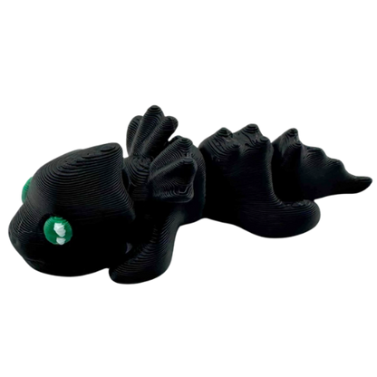 Ember the Dragon Flexling toy in dark gray with black eyes, poseable dragon figure from limited Original Crew edition