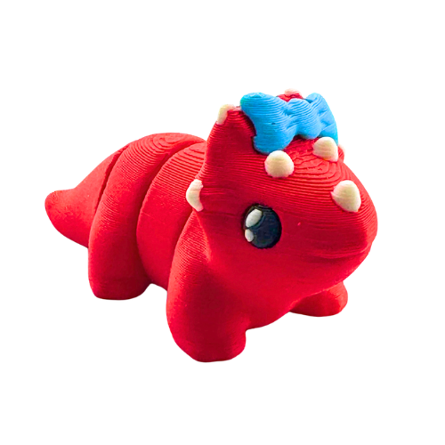 Red triceratops toy with large blue bow on frill, Fancy Edition collectible figure
