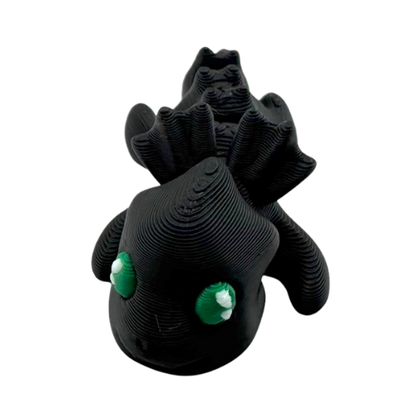 Ember the Dragon Flexling toy in dark gray with black eyes, poseable dragon figure from limited Original Crew edition