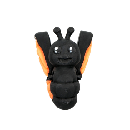 Aurora the Butterfly Flexling with black body and iridescent blue-green wings, poseable collectible toy from Original Crew