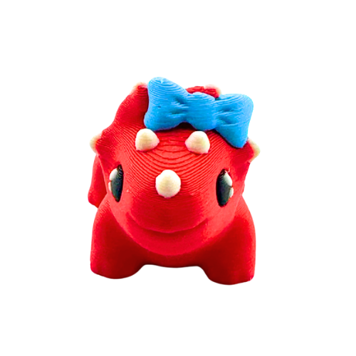 Red triceratops toy with large blue bow on frill, Fancy Edition collectible figure
