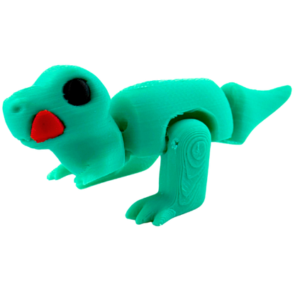 Roary the T-Rex Nom Nom Edition collectible toy in shimmery turquoise finish with tongue out in playful hungry pose