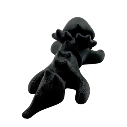 Ember the Dragon Flexling toy in dark gray with black eyes, poseable dragon figure from limited Original Crew edition