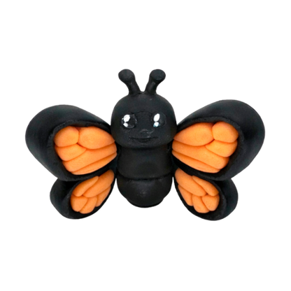 Aurora the Butterfly Flexling with black body and iridescent blue-green wings, poseable collectible toy from Original Crew