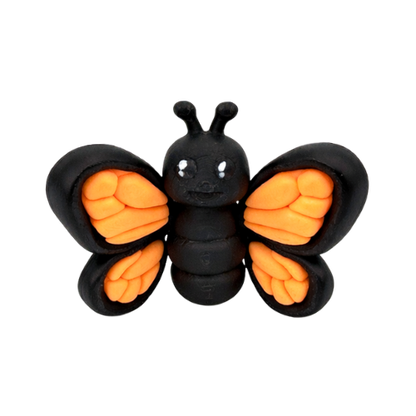Aurora the Butterfly Flexling with black body and iridescent blue-green wings, poseable collectible toy from Original Crew