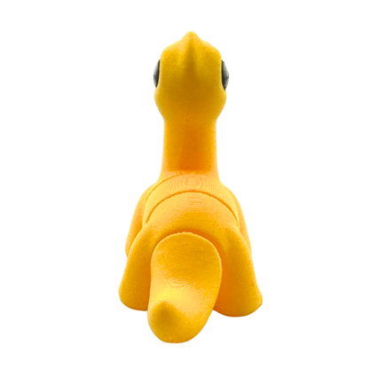 Monty the Brachiosaurus yellow poseable dinosaur figure wearing bow tie from Flexlings Original Crew collection