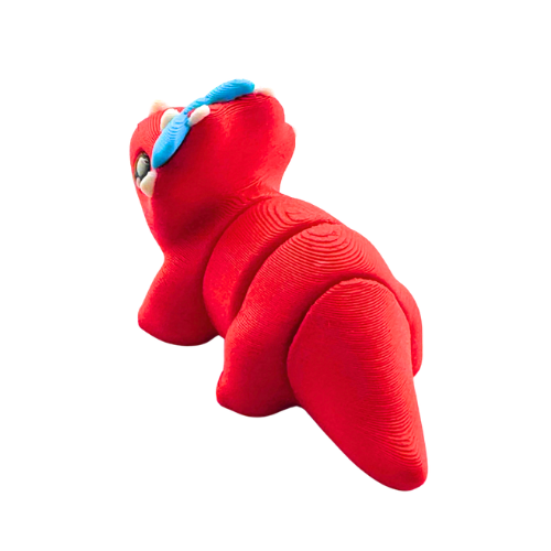 Red triceratops toy with large blue bow on frill, Fancy Edition collectible figure