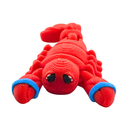Red poseable lobster toy with blue rubber bands on claws, Clawdia the Lobster Caught Edition by Flexlings