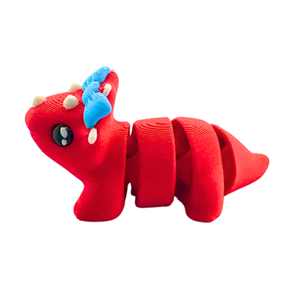 Red triceratops toy with large blue bow on frill, Fancy Edition collectible figure